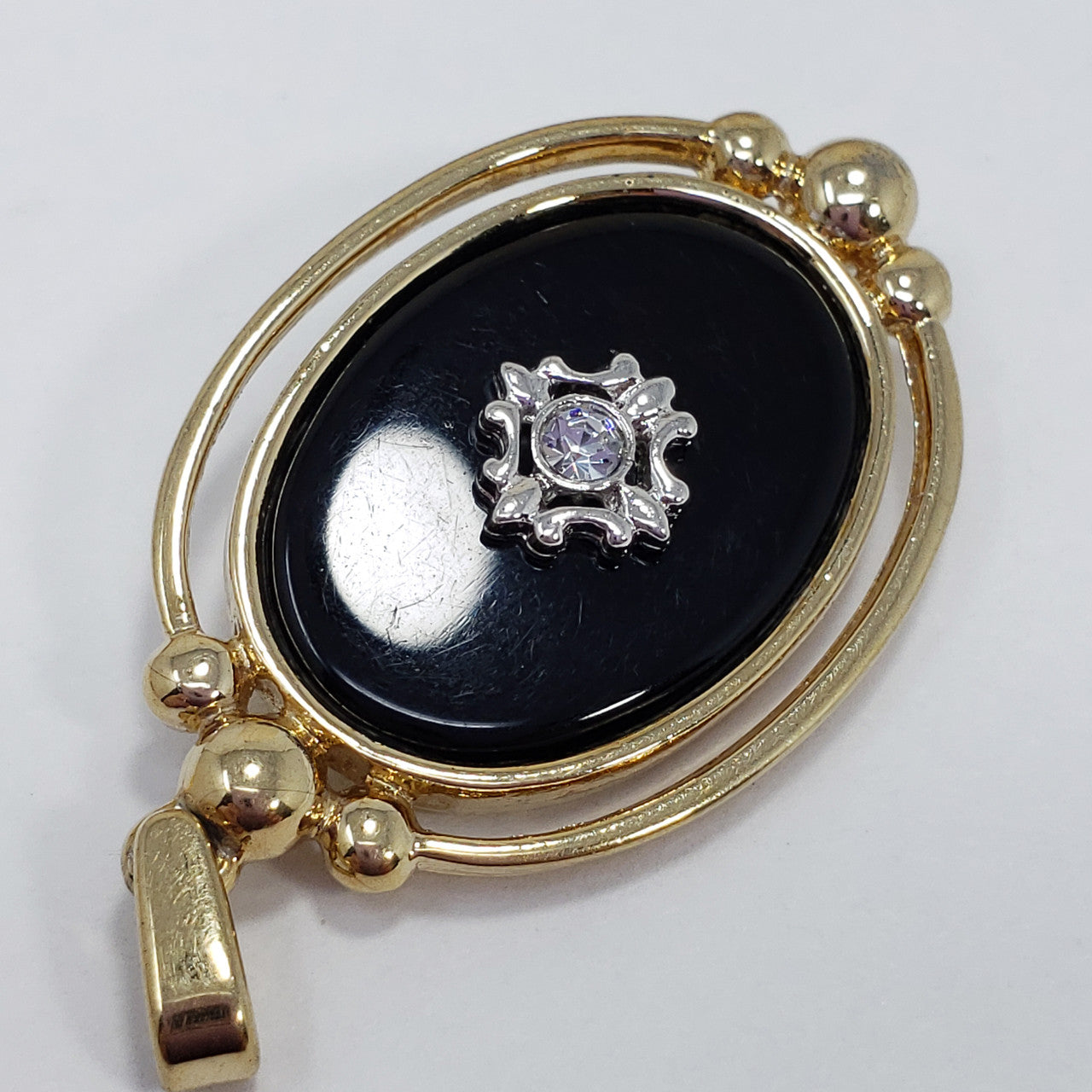 Two Sided Reversible Pendant Black and Gold-tone With Crystal Accents and Raised Metal Designs
