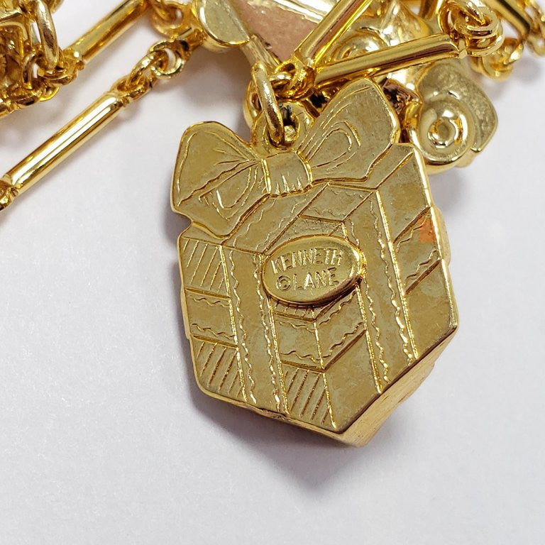 Kenneth Jay Lane Bar Link Charm Necklace in Gold, features Trophy, Car, Golf