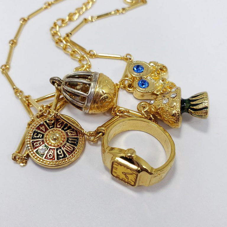 Kenneth Jay Lane Bar Link Charm Necklace in Gold, features Ring, Tree, Roulette